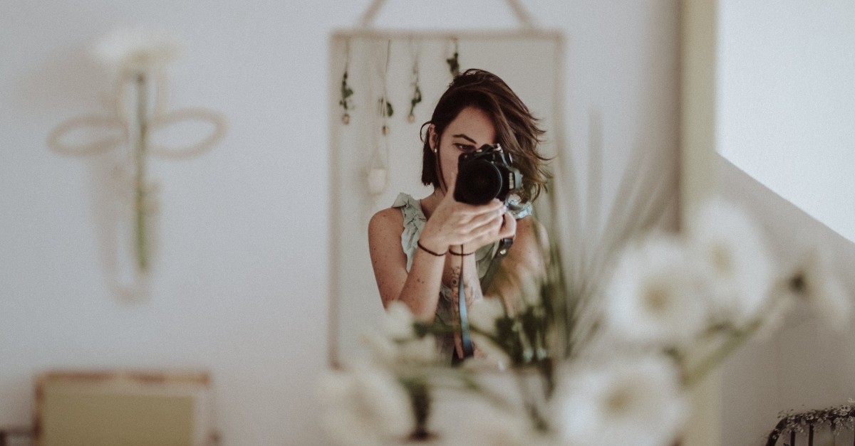 woman taking picture of mirror and home decor, lifestyle