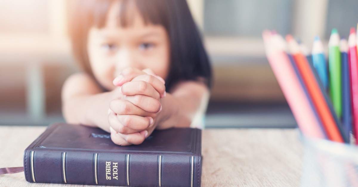 a kid with a Bible, LA Archdiocese files lawsuit against LAUSD for allegedly keeping federal funds from Catholic schools