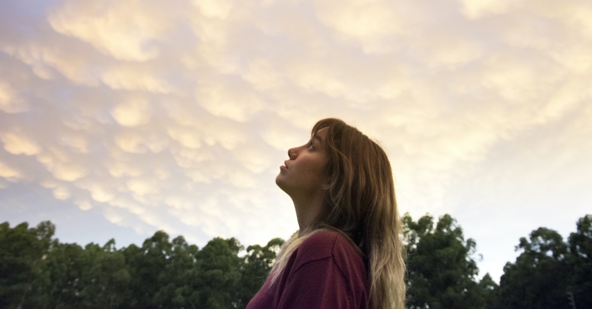 young woman looking up at sky