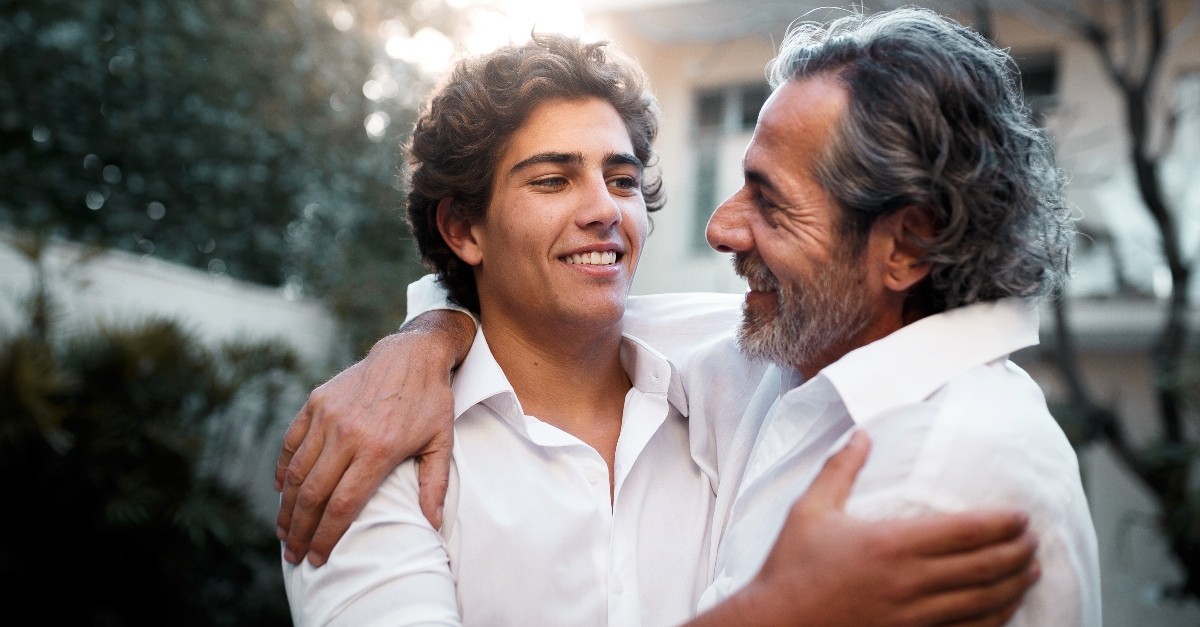 Father and son embracing