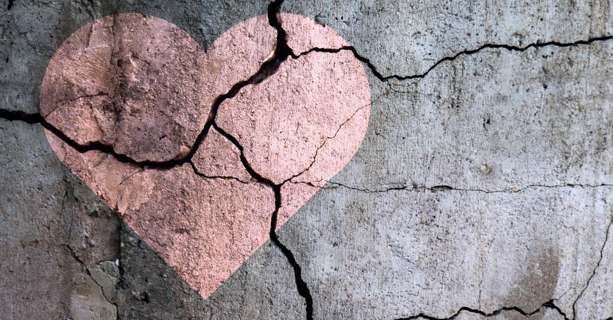 Chalk heart in cracked pavement