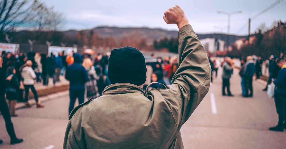 Man with fist raised in protest