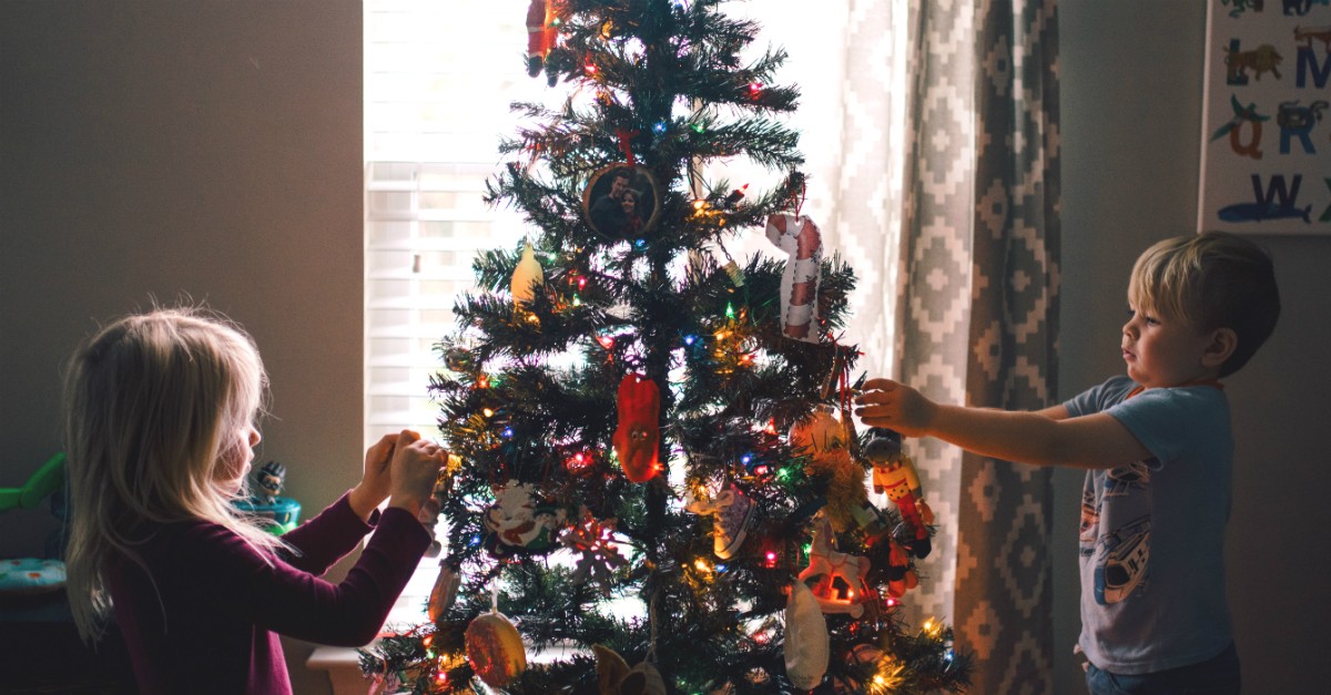 Young kids decorating a Christmas tree