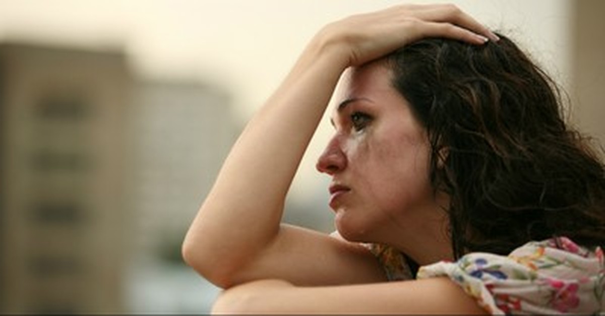 woman crying on balcony, things you should know about trauma