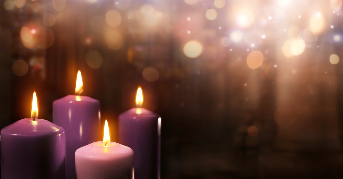 Advent candles with a soft, glowing background; significance of prayer candle colors
