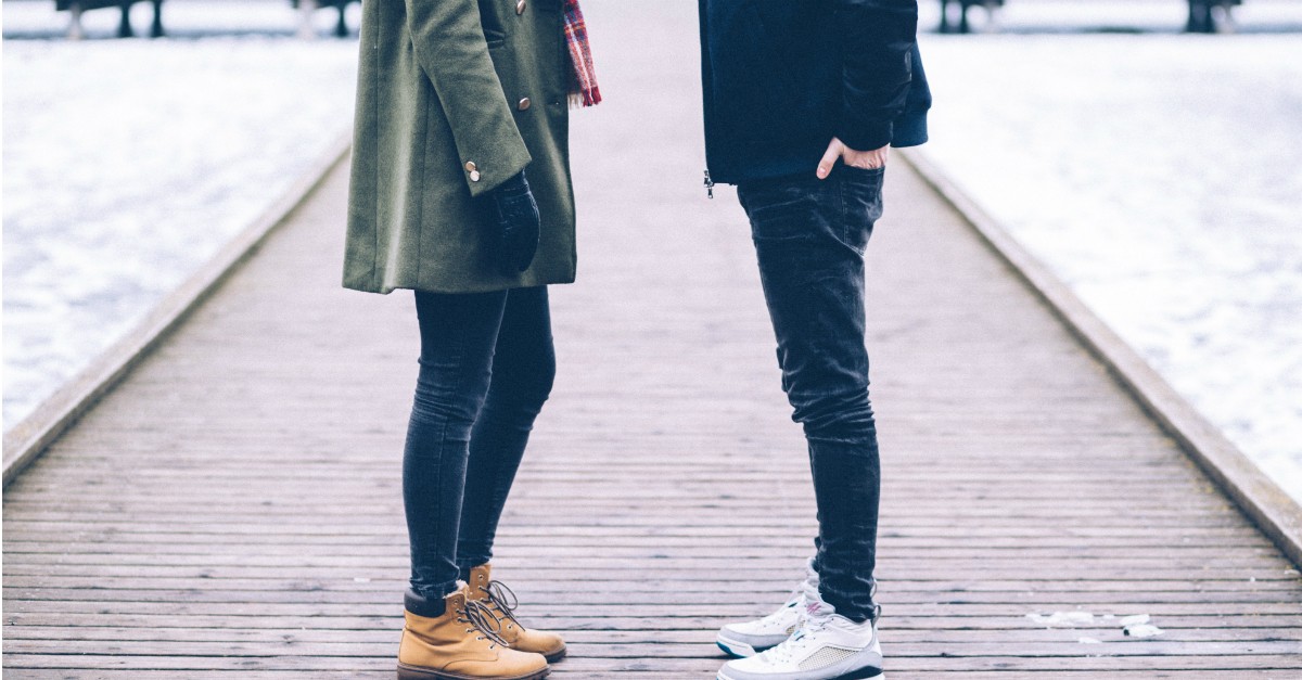 two people talking with each other in winter clothes