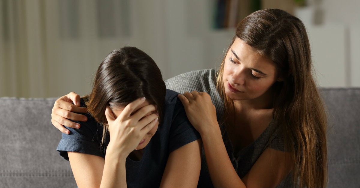 friend comforting a sad friend, things you should know about trauma