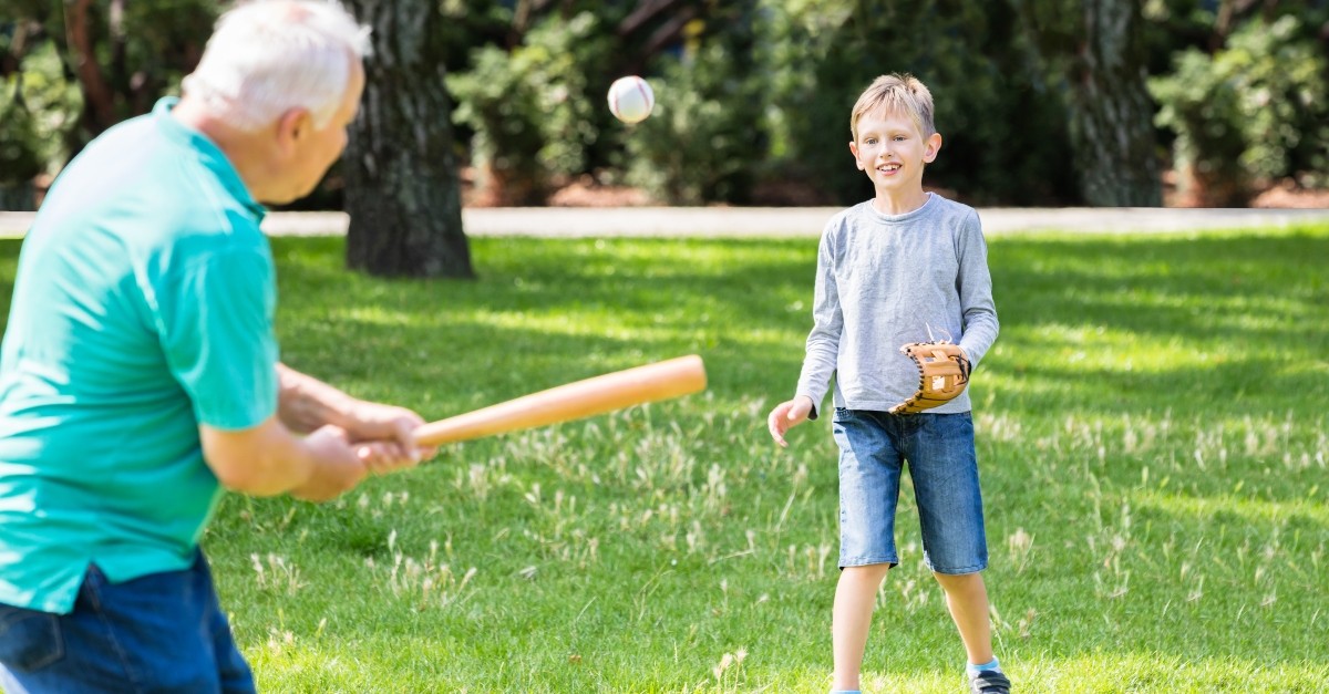 granddad playing baseball with grandson