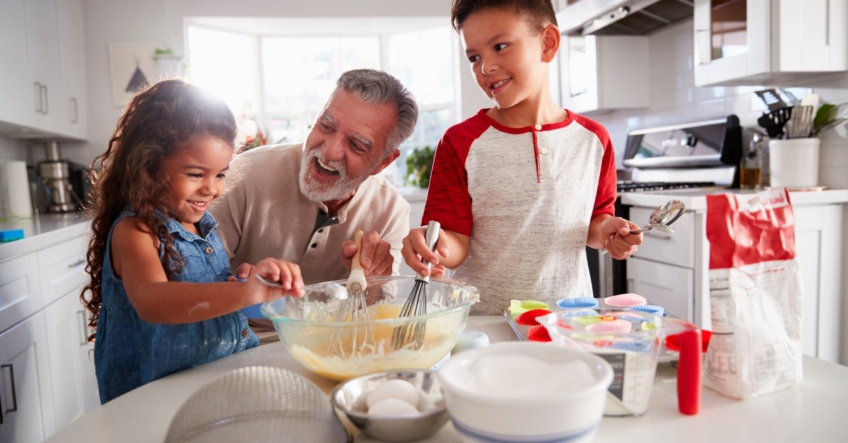 grandchildren baking with grandparent