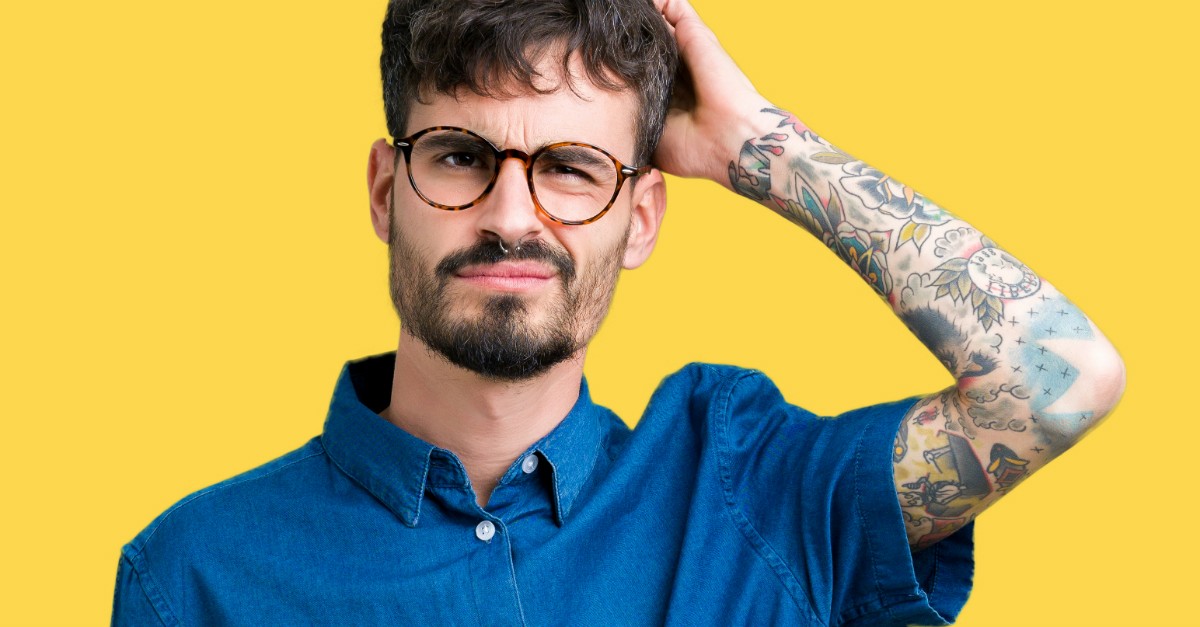man with tattoo scratching his head, christian lies culture