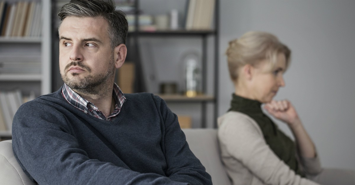 man and woman looking upset not talking to each other