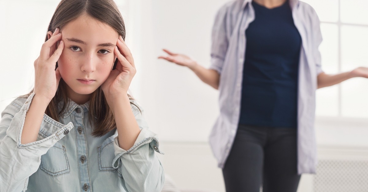daughter looking annoyed at mom talking to her, tension between you and your children