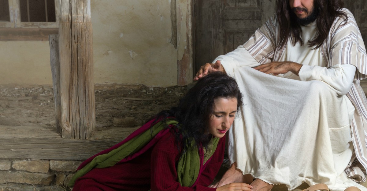 woman kneeling at jesus' feet