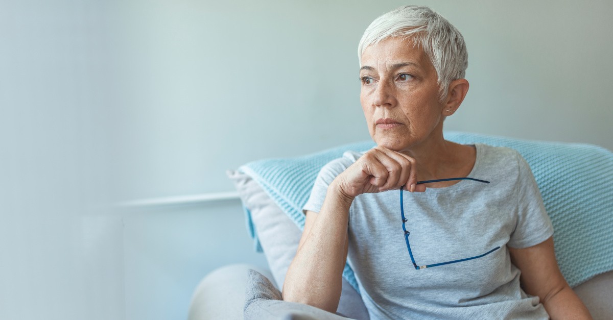 elderly woman looking worried alone, empty nester