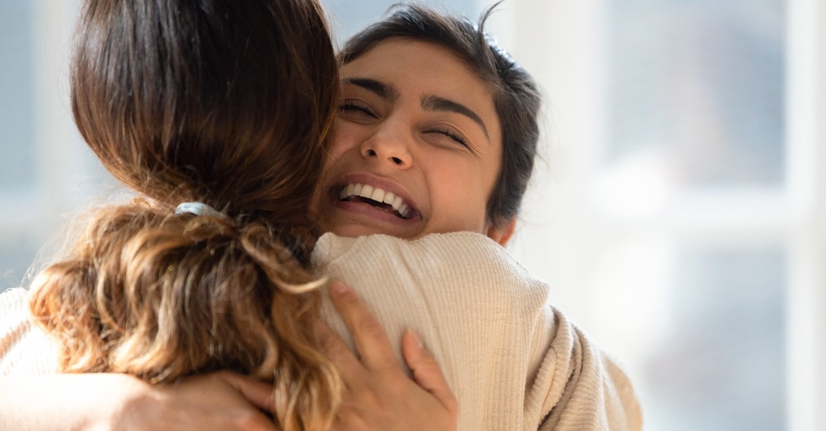 Woman hugging another in support