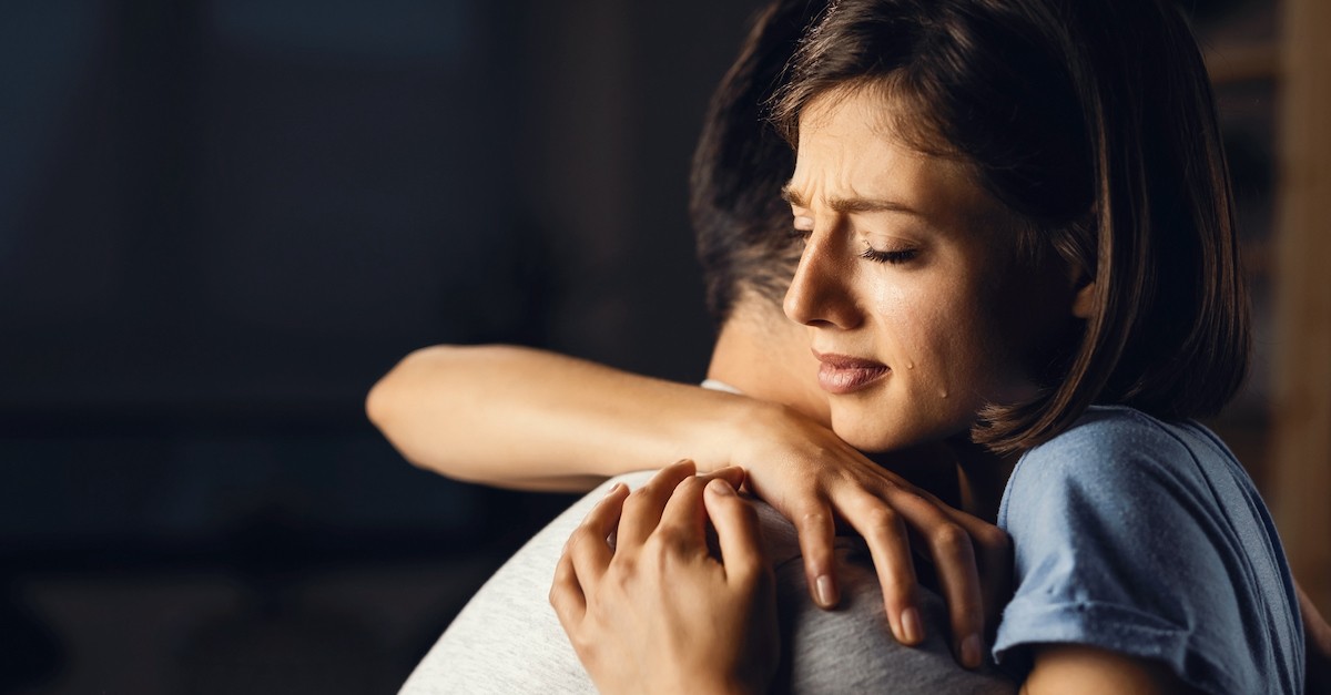 Comforting grieving spouse crying