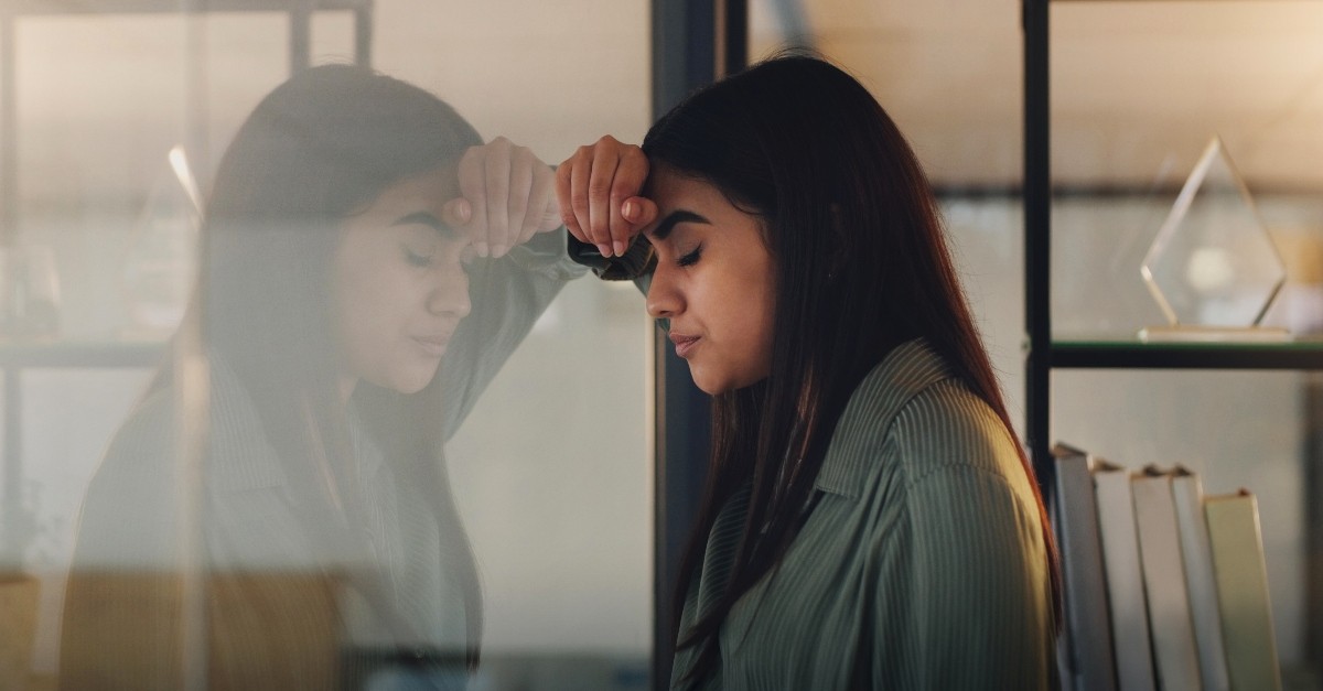 Woman looking depressed at her reflection