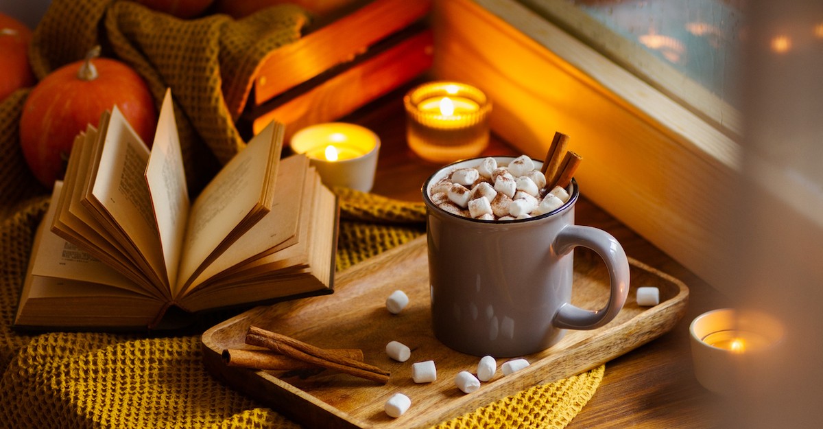 Cozy fall book and mug and pumpkins