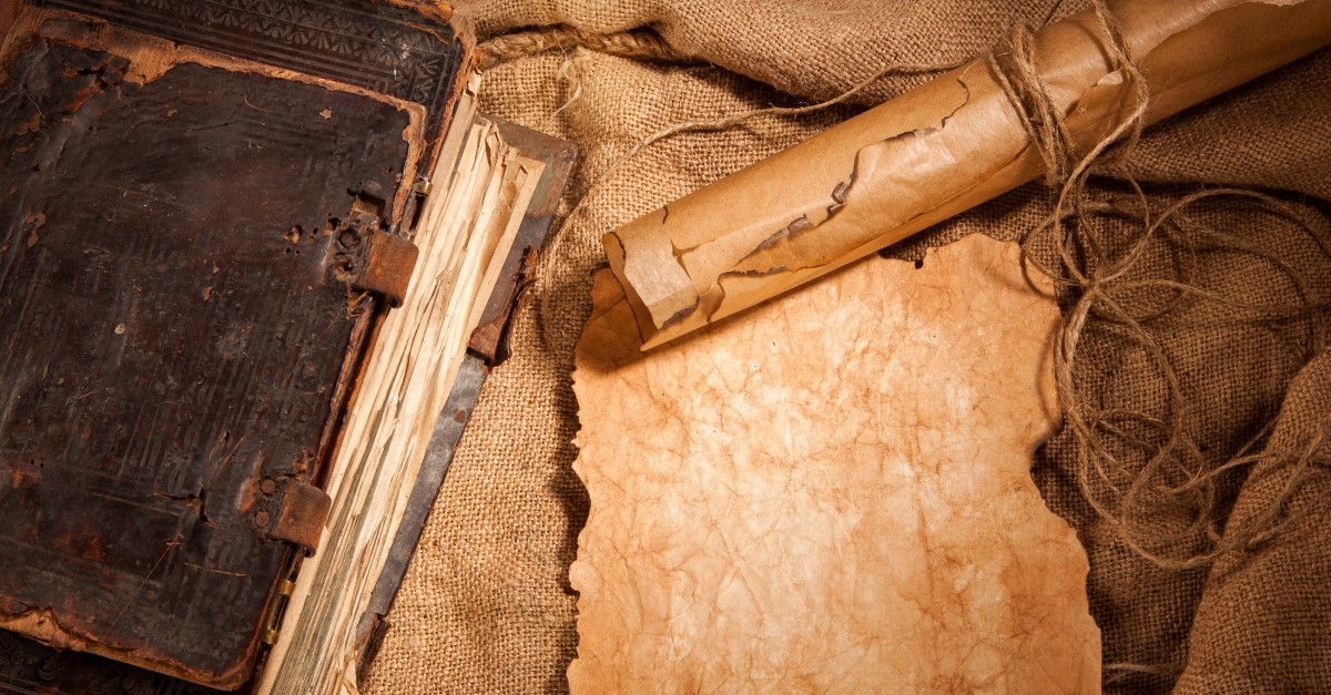 scroll and old book on table, christian history