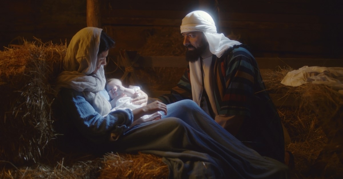 Mary holding baby Jesus with Joseph nearby, Christmas