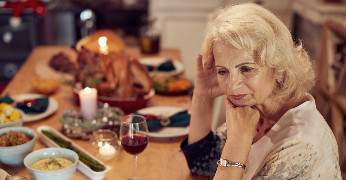 Woman looking upset at Thanksgiving table