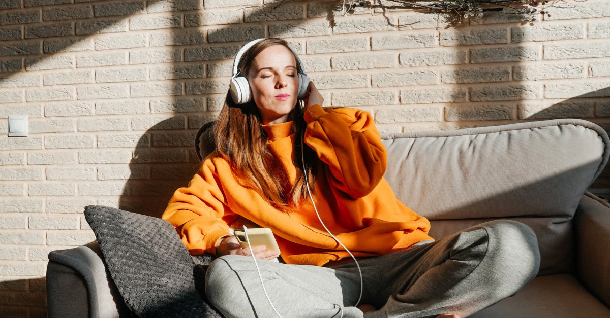 a girl listening to headphones, ASMR cannot replace human presence