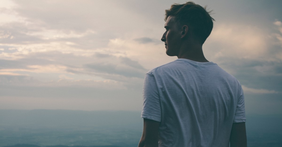 Man in white sheet looking at horizon; shift your focus. 