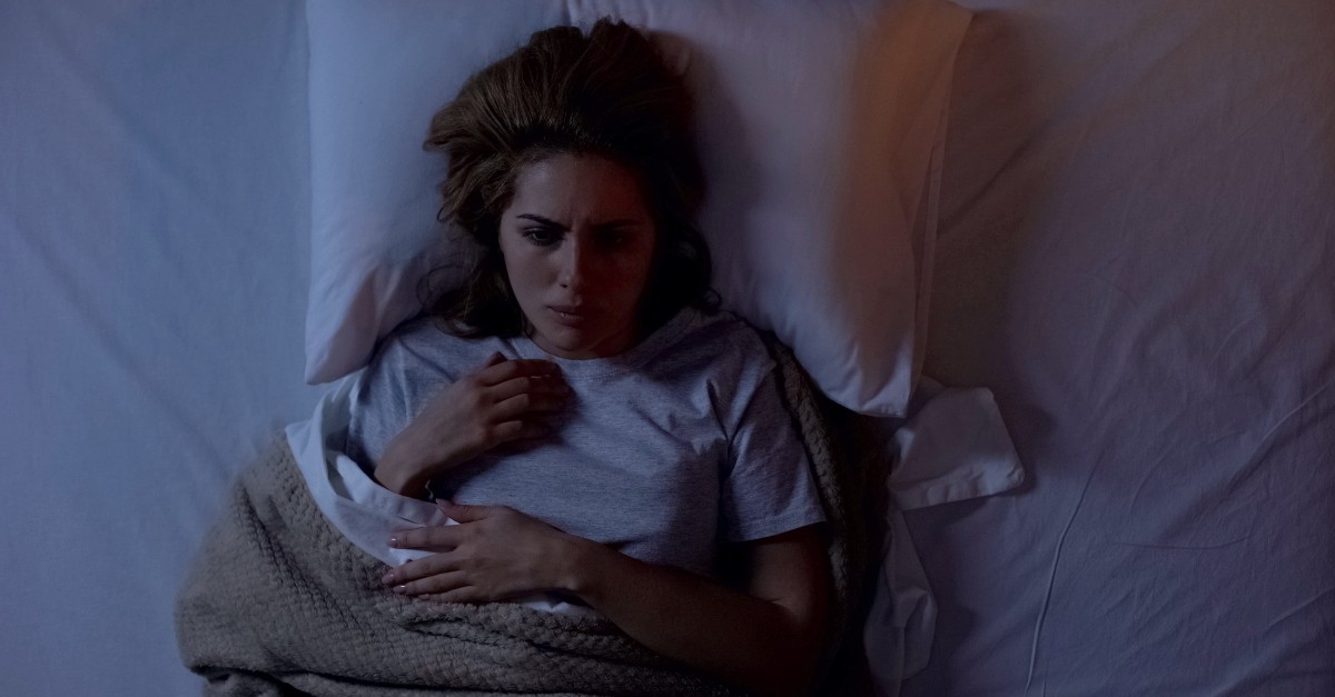 Woman lying awake in fear