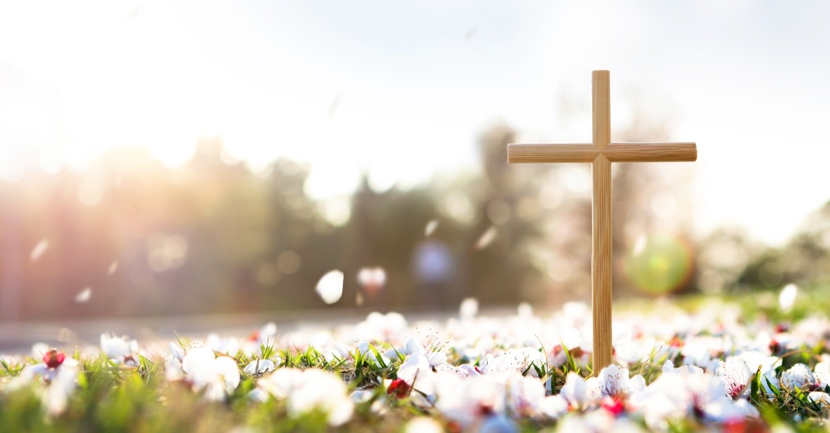 Cross amongst flower petals, celebrate Christian holidays