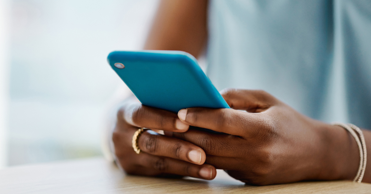 Woman disconnected, focused on cell phone in her hands.