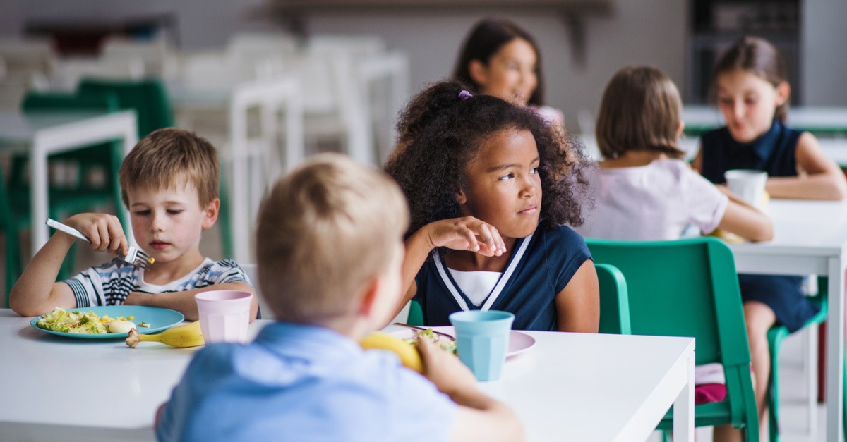 kids in a cafeteria, church pays off over $20k in student lunch debt