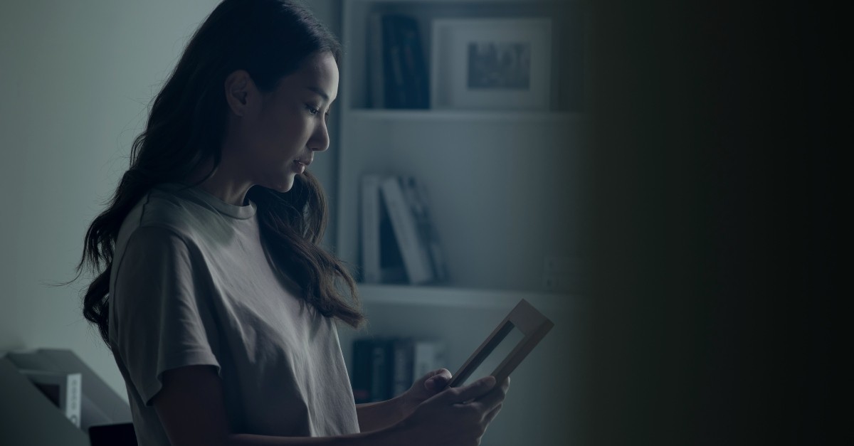 Woman looking at a framed picture