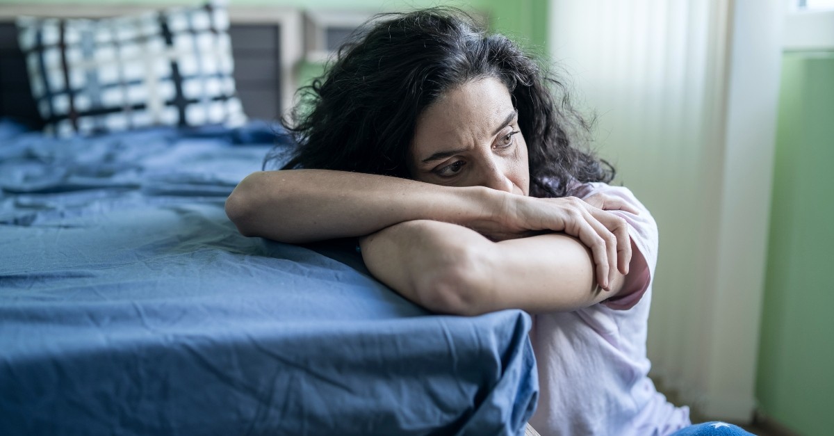 Woman leaning on her bed