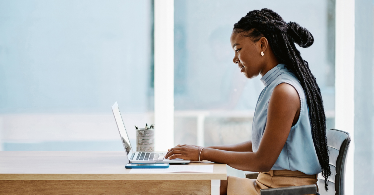 Woman working on her computer at an office; healthy work-life balance