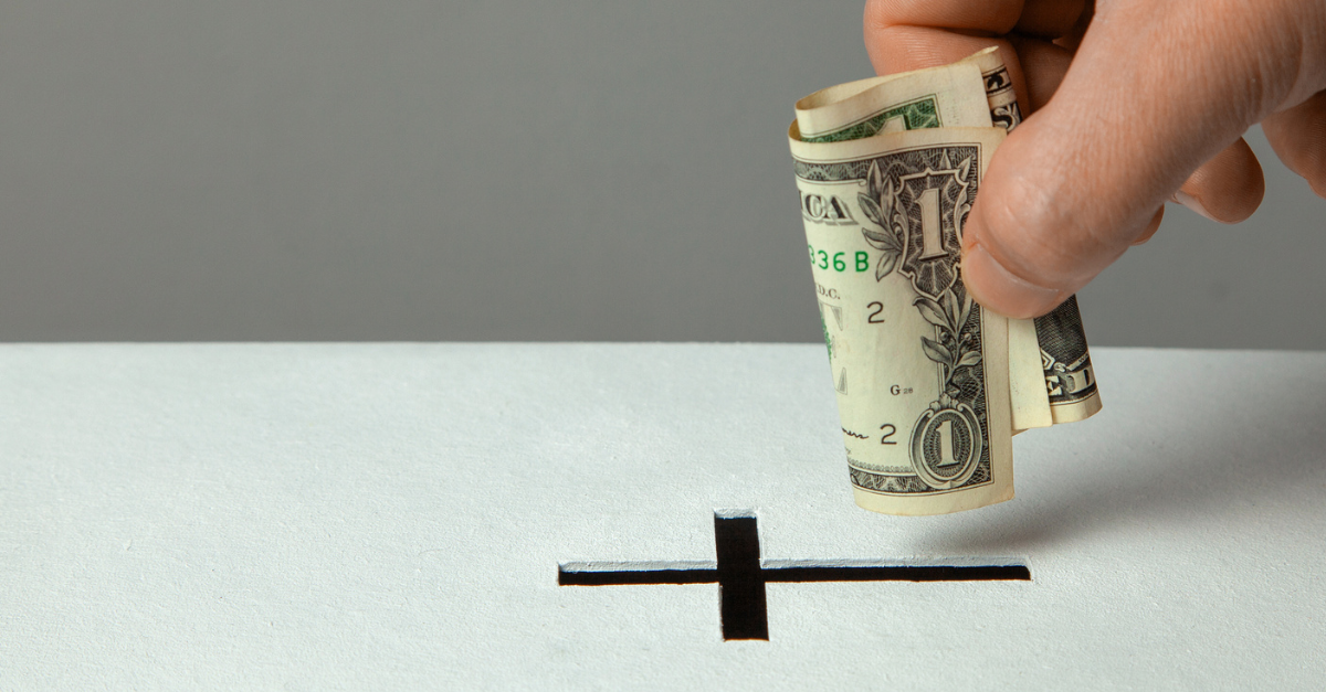 Hand putting money in a giving box at church; 4 things you must do every time you give.