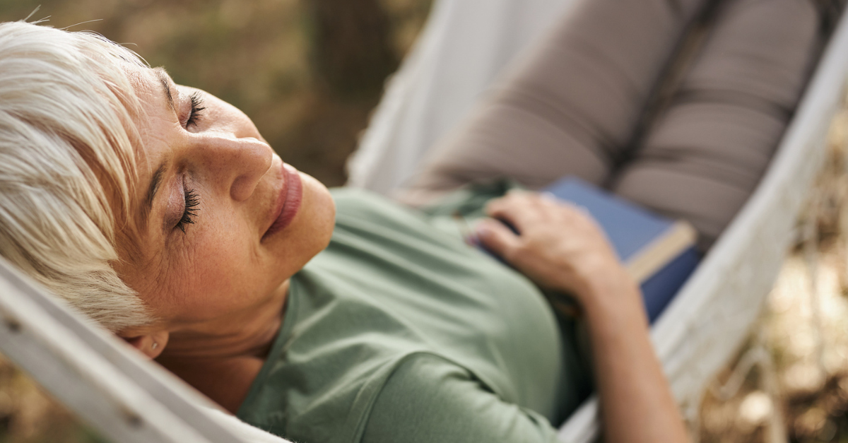 Woman relaxing in a hammock; REST: A Summer Formula for Restoration.