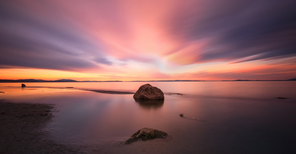 Still water at sunrise; the practice of stillness.