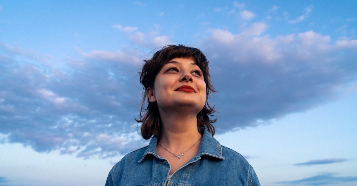 Woman standing behind the evening sky