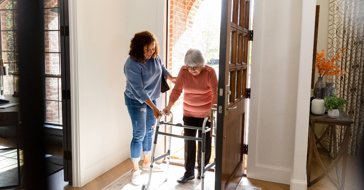 Woman helping an elderly woman