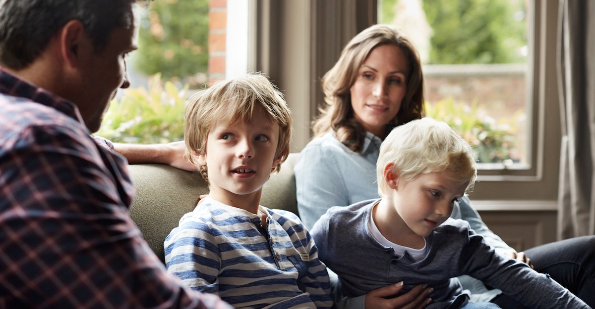 Family on couch parents talking to kids