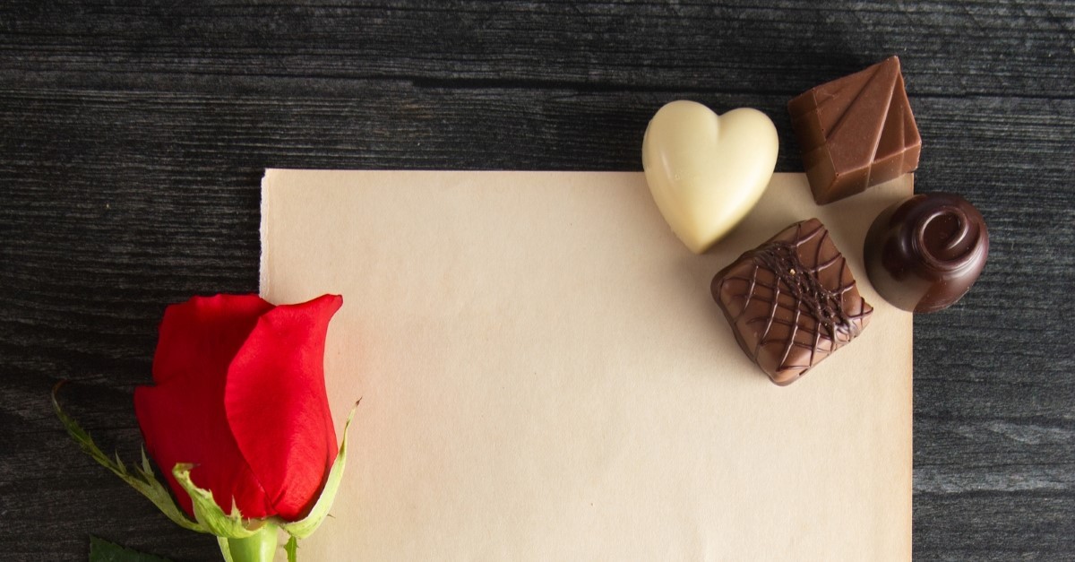 letter with rose and chocolates to illustrate love letter for husband