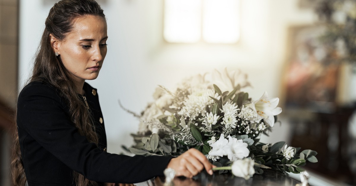 Sad widow woman crying at funeral