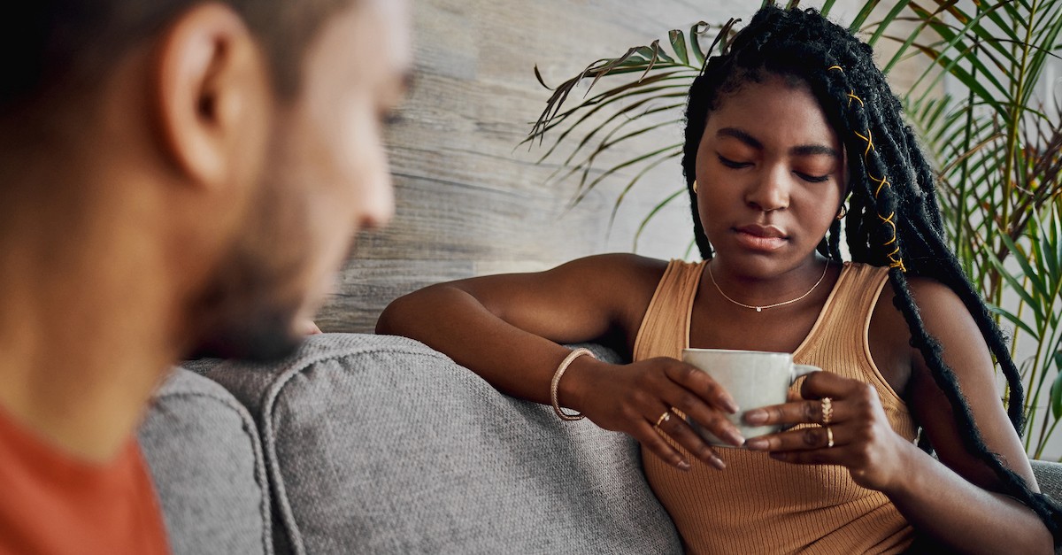 Sad couple on couch breaking up