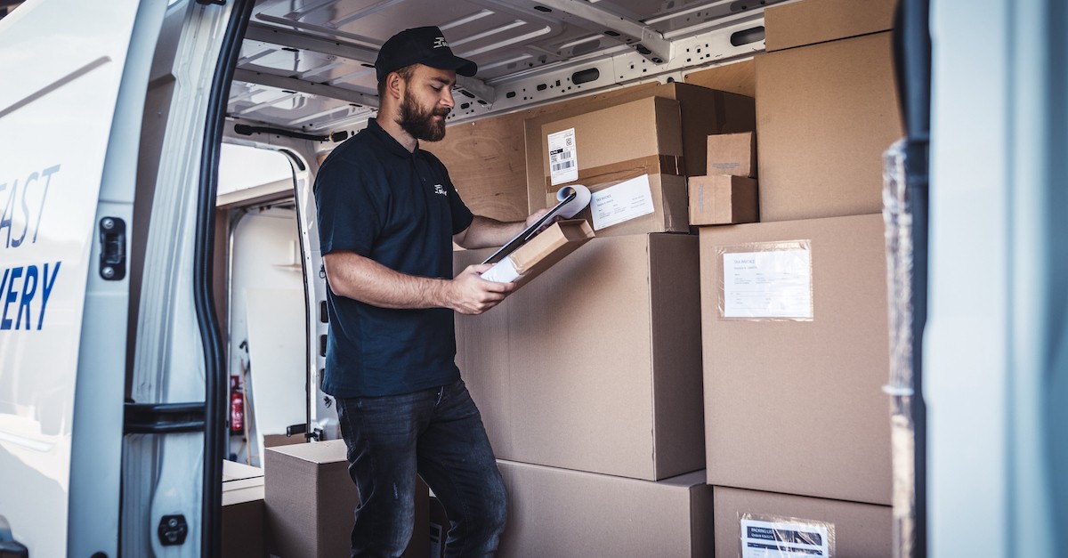 Delivery man at work in car