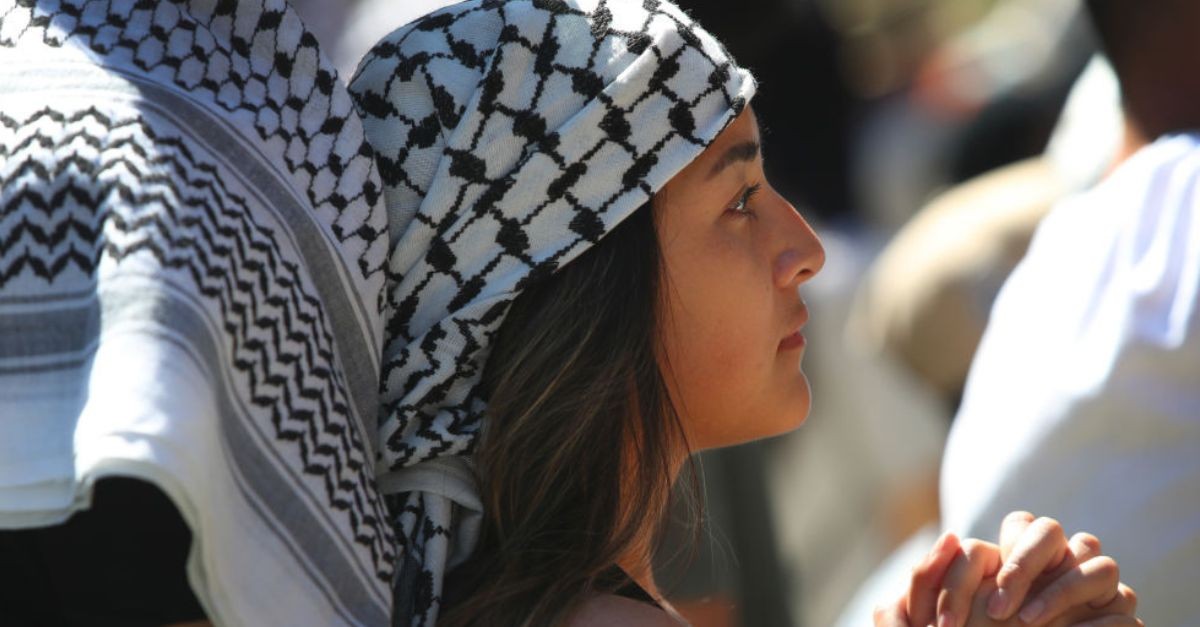Woman praying for Palestine;