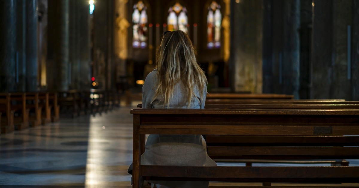 Woman sitting alone in a sanctuary