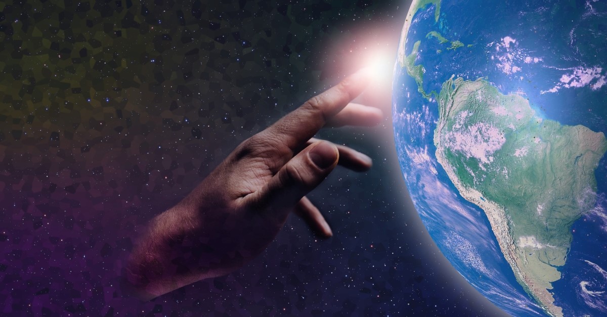 hand of god touching planet earth