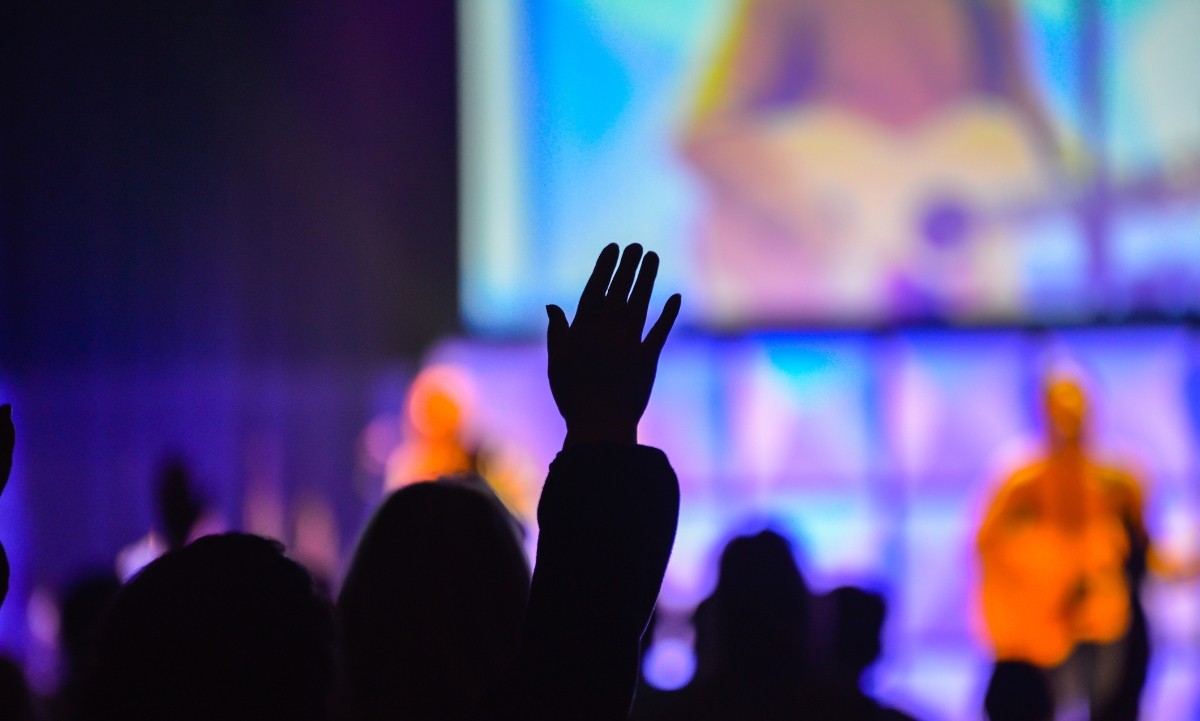 Hand raised in worship, reasons to get involved in church when your schedule is full