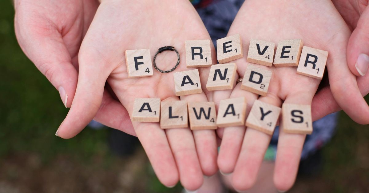 Couple's Hands Holding Scrabble Letters Spelling 'Forever and Always'