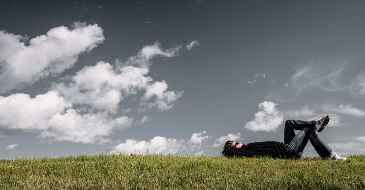 Man lying on the grass thinking